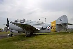 Gannet T.2; three cockpits, nose high stance, exhausts next to wing trailing edge, rounded off tailfin