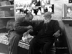 Two men sitting together