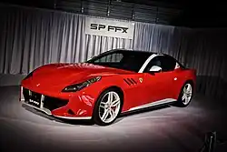 Front three-quarters view of a red coupe