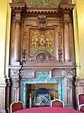 Fireplace in the Council Chamber, surmounted by a painting of the Royal coat of arms of Scotland