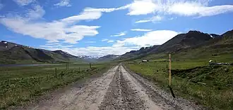 A road through Flókadalur on a sunny day
