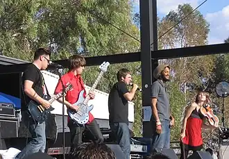 Flobots at KFMA Day in Tucson, Arizona on May 16, 2008. From left to right: Andy Guerrero, Jesse Walker, Jamie Laurie, Stephen Brackett, MacKenzie Gault
