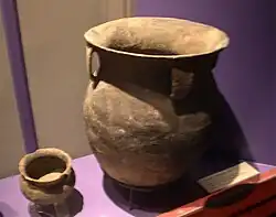 A large storage jar with cord-marked decorations and strap handles
