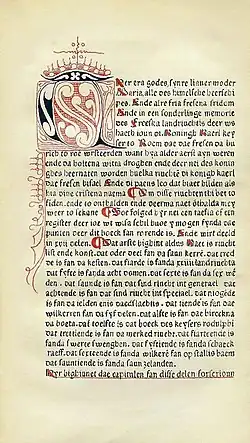 A manuscript written in very thin blackletter font with red ornimentation throughout; the incipit begins with an extremely ornate letter which is colored in both red and black