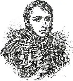 Black and white print of a man with curly hair and very long sideburns. He wears a hussar uniform of the Napoleonic era (1800-1815).