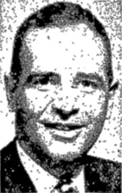 Black and white portrait style photo of a Caucasian man about 40 years of age