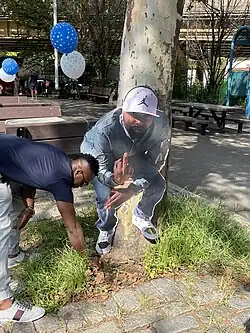 Homemade memorial in Brooklyn, NYC featuring a photo cut-out of the deceased giving the middle-finger