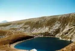 Golemo Ezero surrounded by land scattered with snow