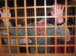 A man holding wooden bars