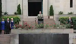 Colour photo of a man wearing military uniform standing at a lectern