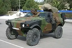 Front view of a VBL with a French-style camouflage. The older Greek flag is painted on its license plate.