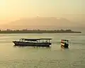 View from Gili Trawangan; in the foreground are island hopper boats anchored off Gili Trawangan, Gili Meno is the next island — Ginung Rinjani is in the distance