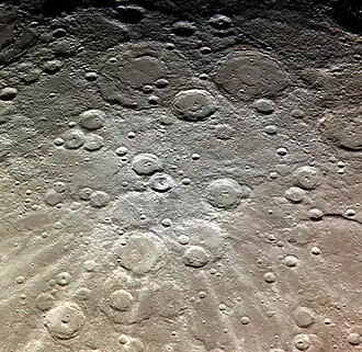 Exaggerated color image by MESSENGER with Bernini, Cervantes, and Van Gogh at top