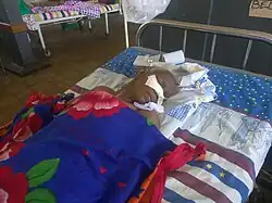 image of an old person lying on a bed in Iganga hospital in Uganda