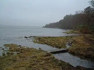 The sea seen from the bay, with a small path running on the coastal edge