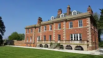 South facing Georgian house looking out on to lawned gardens. Used as a beautiful wedding venue