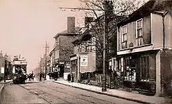 1920s street scene of The Brook passing King Street in Chatham, with period buildings and pedestrians