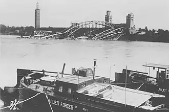 Half a bridge lying collapsed in a river
