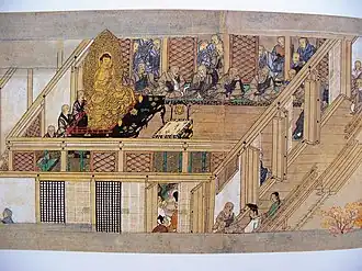 Monks gather for a debate in a Buddhist temple room walled with shoji