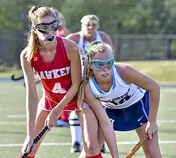 Field hockey players representing Hawken School (left) and Hudson High School (Ohio) (right) wearing protective goggles and mouthguard