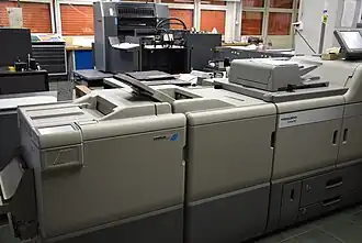 In the foreground a Linoprint digital printing machine, in the background a Heidelberg offset printing unit