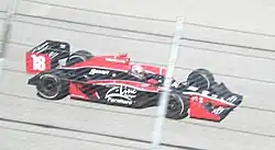 Wilson driving his car on a track