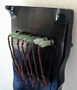 Ornate jade tuning pins on a guqin