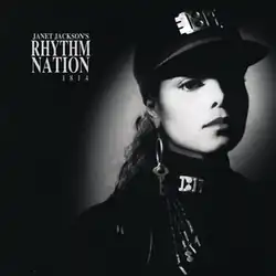A young woman photographed in black and white wears an all-black, military-styled uniform accented by silver-plated accessories. A spotlight shines on her face. To her left reads the text "Janet Jackson's Rhythm Nation 1814".