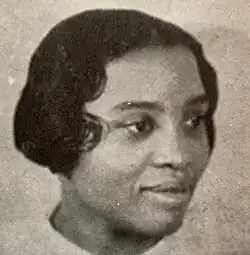 Portrait of an African American woman with short hair facing right.