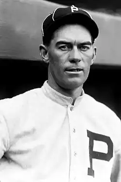 A man in a baseball uniform is shown from the chest up looking forward.