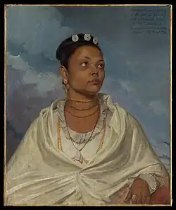 An oil painting depicting Joanna de Silva, an Indian woman, from waist up, looking into the distance. She wears delicate white clothing and has jewellery around her neck and in her hair, and a ring on her finger. An inscription states Joanna de Silva, a native / of Bengal, the faithful / and affectionate Nurse / of the Children of / Lieutenant Colonel Charles Deare / Painted by Will:m Wood 1792