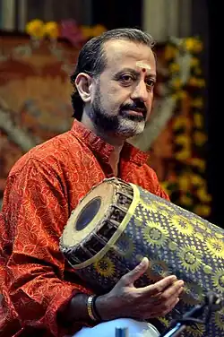 KV Prasad playing the mridangam in a concert