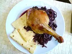 Roasted duck leg with greasy lokše and stewed red cabbage