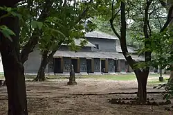 Kalo Bari – the house built with mud and coal tar. Click on the pic to enlarge for a glimpse of the wall decoration.