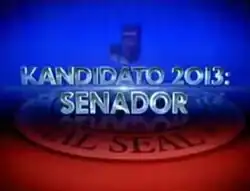 An image of a chair, over a blue and red background. The show title is displayed on the center of the image.