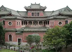 Internal courtyard of the mansion, looking North, showing the three-sided veranda on the first floor and the building's swooping green rooflines