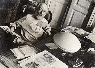 Russian scientist Konstantin Tsiolkovsky at his desk, examining papers