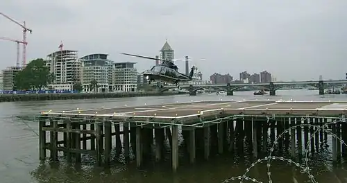 Image 15Helicopter landing at London Heliport, a jetty constructed in the River Thames in Battersea.