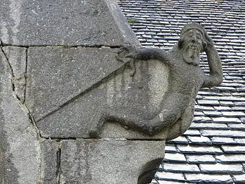 Unusual carving on church exterior at Loqueffret
