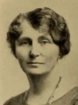 A white woman with wavy hair dressed close to her head