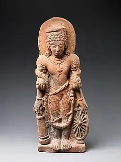 A statue of Vishnu Caturanana ("Four-Armed"), using the attributes of Vāsudeva, with the addition of an aureole around the head (5th century CE)[67]
