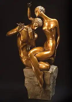 Sculpture of a man playing a flute as a woman listens