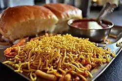 Misal pav topped with Indian snack farsan or sev
