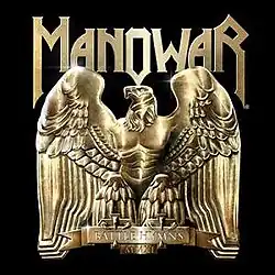 A metallic statue of an eagle with prominent human-like chest muscles, with a logo reading "MANOWAR". the statue's label reads "BATTLE HYMNS MMXI".