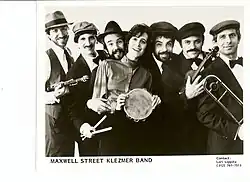 People lined up with instruments are posing in a black and white photo