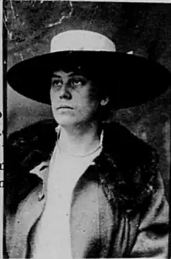 A woman wearing a hat and looking away from the camera