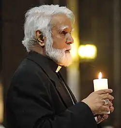 Coutts holding a candle