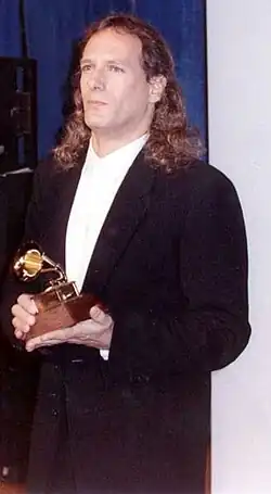 Michael Bolton holding his Grammy award in 1990.