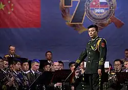Band director Zhang Haifeng conducting a group of musicians in the Military Band of the Western Military District.