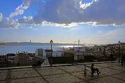 The scenic overlook of Miradouro da Santa Catarina, showing a view of the Tagus River and local neighborhoods